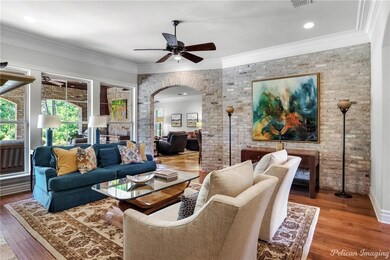 A brick archway leads to a formal living room with