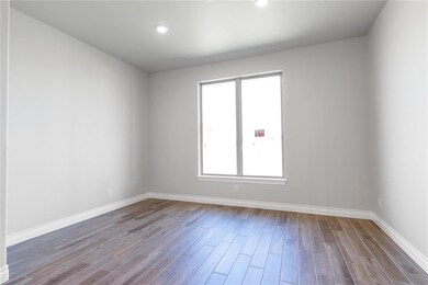 Unfurnished room with dark wood-style floors and recessed lighting