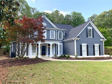 Traditional-style house with a front lawn, a porch