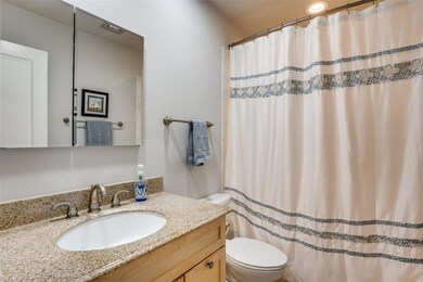 Second bathroom located off the hallway to the sec