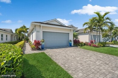 View of front of home with stucco siding, an attac