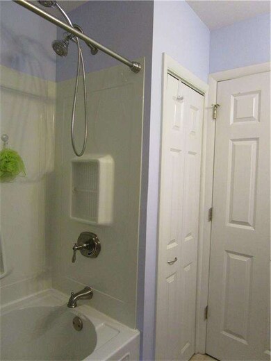 Nice shower/tub surround and linen closet in bathr