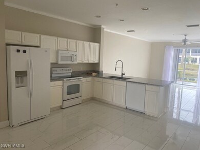 Kitchen featuring white cabinets, white appliances, kitchen peninsula, and sink