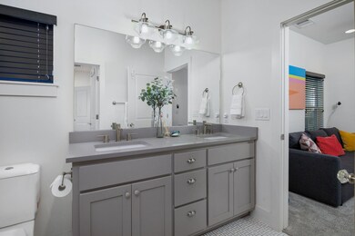 Bathroom featuring connected bathroom, double van