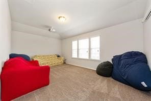 Sitting room with carpet, lofted ceiling, and a wall mounted air conditioner