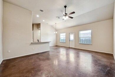 Unfurnished living room with concrete floors, a c