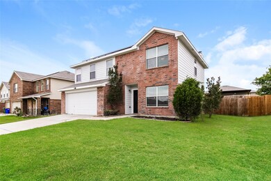 View of front of property with a garage and a front lawn