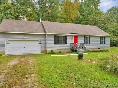 View of front of property with a garage and a front lawn