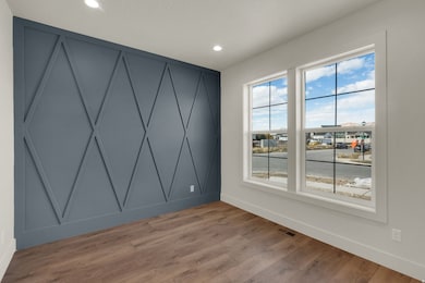 Empty room with wood finished floors and recessed lighting