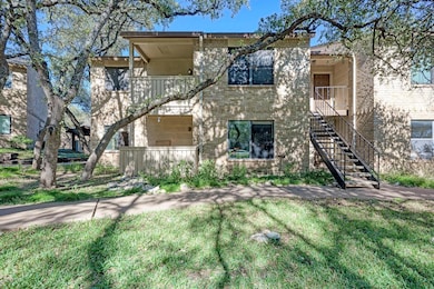 View of front facade with a balcony, brick siding