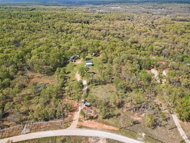 Aerial view featuring a wooded view