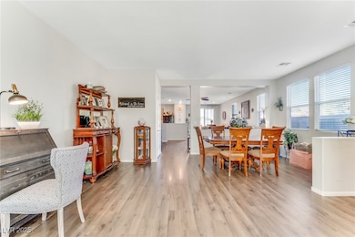 Dining space featuring light wood-style flooring and baseboards