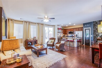 Living area with a ceiling fan, dark wood-style fl