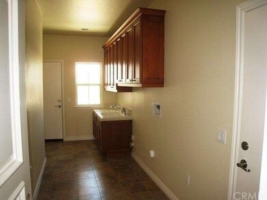 Laundry room with cabinets and laundry sink.