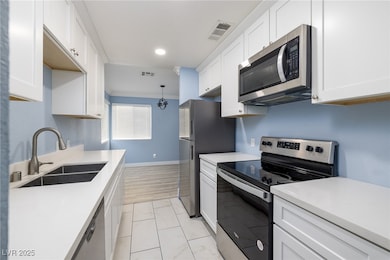 Kitchen includes stainless steel appliances white