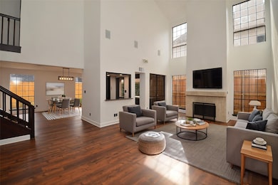 The living room is large, with high ceilings and a