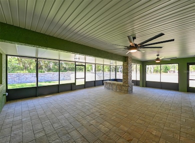 Spacious, paved, enclosed patio with rectangular propane fire pit. Large ceiling fans. Plumbed for outdoor grill.
