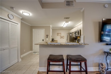 Kitchen featuring ornamental molding, a breakfast