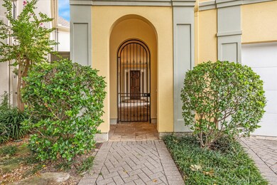 Enter through the gated archway to the residence.