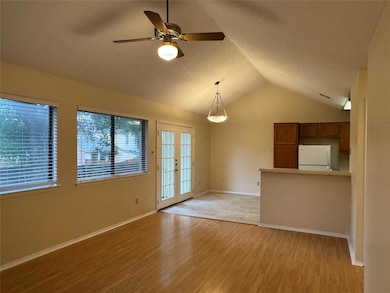 Unfurnished living room with vaulted ceiling, lig