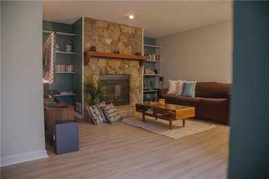 Living area featuring a textured ceiling, wood fin