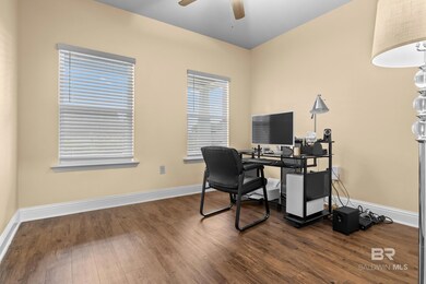 Office area featuring dark hardwood / wood-style flooring and ceiling fan