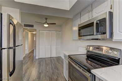 Kitchen featuring a ceiling fan, appliances with s