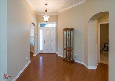 Spacious entry with wood laminate flooring