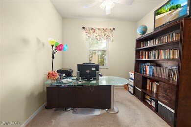 Office space featuring light colored carpet, baseb