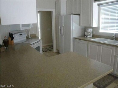 Bright fully equipped kitchen with Corian counter-