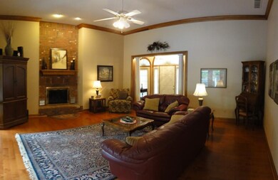 The great room features a floor-to-ceiling brick h