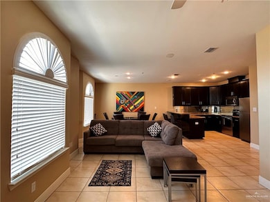 Living room featuring light tile patterned flooring, recessed lighting, and ceiling fan
