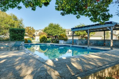 Community pool featuring a pergola and a patio