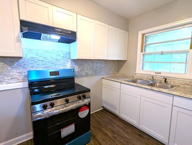 Kitchen with stainless steel electric range, under