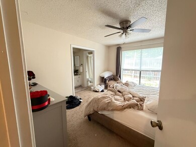 Bedroom featuring a textured ceiling, carpet floo