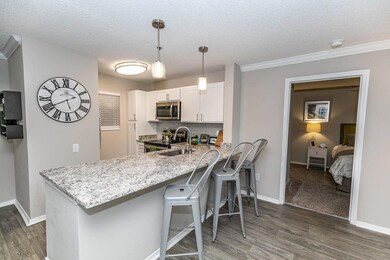 Kitchen featuring white cabinetry, backsplash, dar