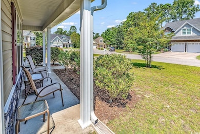 View of patio with a garage and a porch