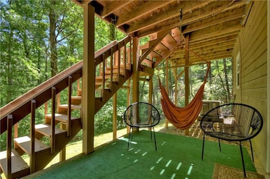 Patio with hot tub, sitting area and hammock