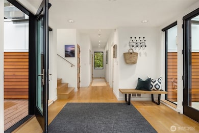 View to the bedroom wing with the front door to the right and garden deck to the left.