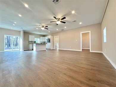 Unfurnished living room with ceiling fan and light