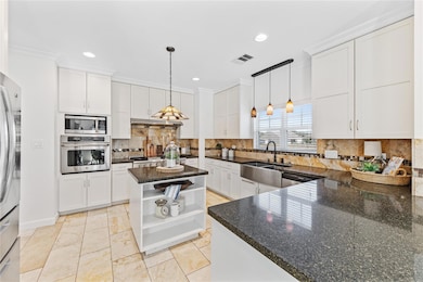 Built in gas stove, island and ample storage and counter space