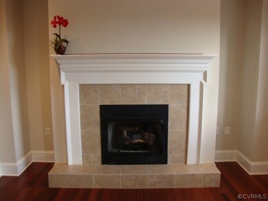 Close up of gas fireplace with white wood mantel