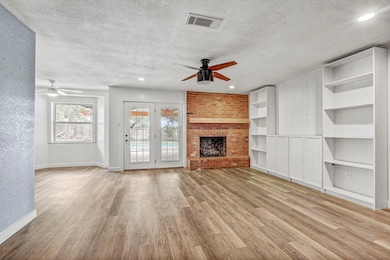 Unfurnished living room featuring ceiling fan, a 