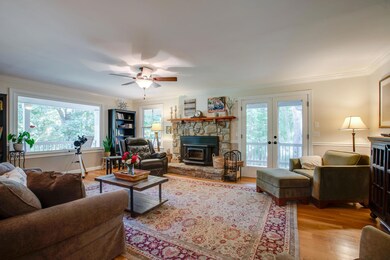 What a perfect spot to watch the leaves change colors, the snow fall and the trees bud again! Such an inviting family room with a real wood-burning fireplace!