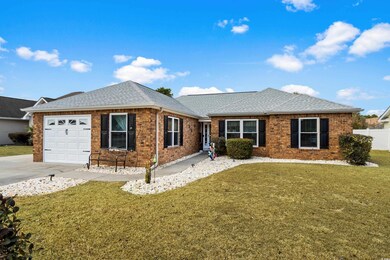 Ranch-style house featuring a garage and a front y
