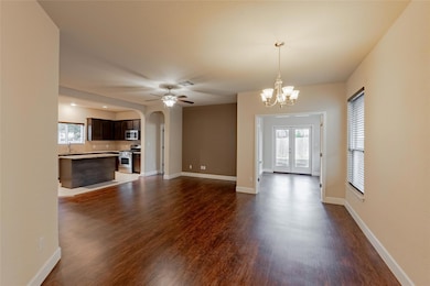 Unfurnished living room with arched walkways, a c