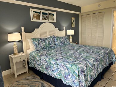 Bedroom with light tile patterned floors and a clo