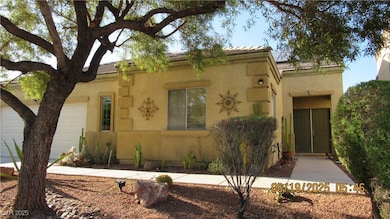 View of front of home with a garage and stucco sid
