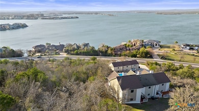 Birds eye view of property with a water view