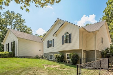 View of side of property with roof with shingles